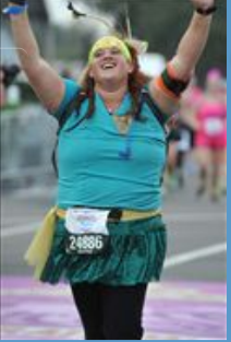 Taryn crossing the runDisney Princess Half Marathon finish line. Fitzness.com